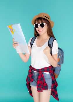 Beautiful happy young asian woman travel looking and success a paper map isolated on blue background, asia girl excited search journey with direction in vacation trip with cheerful for leisure.