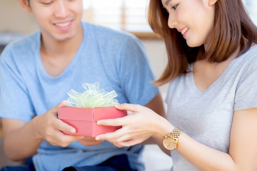 Beautiful young asian couple in love surprise gift box in bedroom at home, family anniversary with enjoy and romantic together wife and husband with relationship, Celebrating Valentine Day concept.