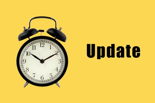 UPDATE text with alarm clock on yellow background. Business Concept