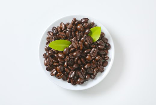 Roasted coffee beans on white plate