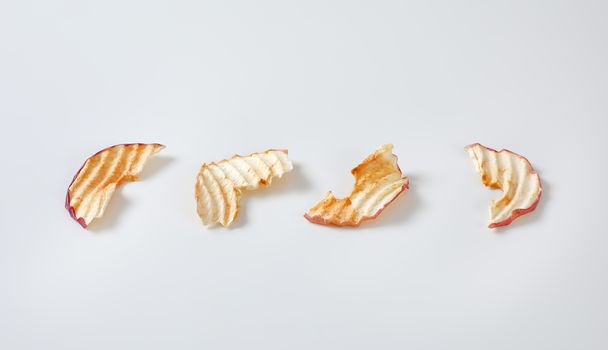 Dried apple slices (apple chips) in a row