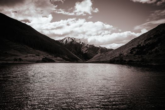 The stunning idyllic Moke Lake near Queenstown in Otago, New Zealand. This secluded, peaceful lake is a popular locale for camping, boating, hiking & horseback riding.