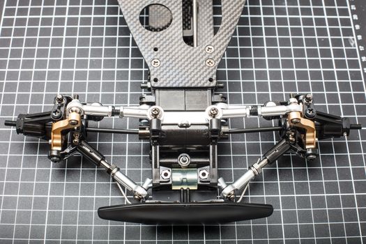 RC car chassis and parts being built to form a radio controlled race car.