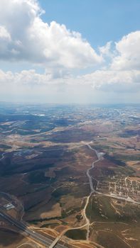 The view from the airplane window to the ground. Landscape view from the sky.