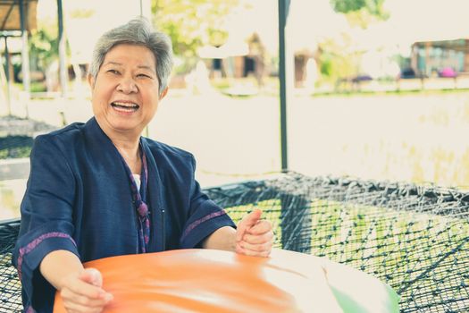 asian elderly woman elder  resting relaxing outdoors. senior leisure lifestyle