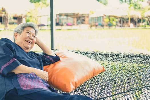 asian elderly woman elder  resting relaxing outdoors. senior leisure lifestyle