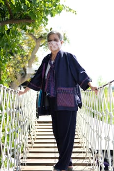 asian elderly woman elder wearing facial mask resting relaxing outdoors. senior leisure lifestyle