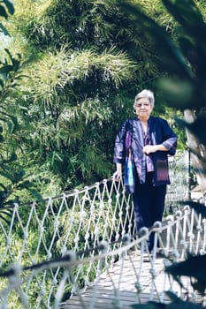 elder woman resting in garden. asian elderly female relaxing outdoors. senior leisure lifestyle