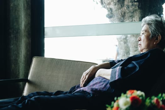 asian elder female woman resting relaxing on sofa at home. elderly senior leisure lifestyle
