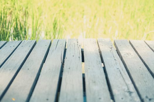 wooden table with rice paddy field background for montage display product
