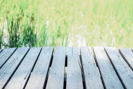wooden table with rice paddy field background for montage display product