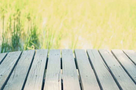 wooden table with rice paddy field background for montage display product