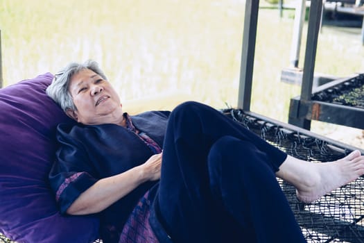 asian elderly woman elder  lying resting relaxing outdoors. senior leisure lifestyle