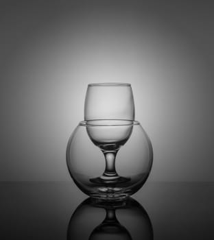empty drink glasses placed one after another on dark background with back light.