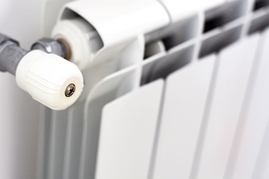 close-up view of the white knob that adjusts the temperature of the radiator. Heating and winter season