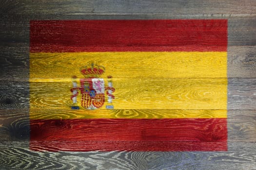 A Spain flag on rustic old wood surface background

