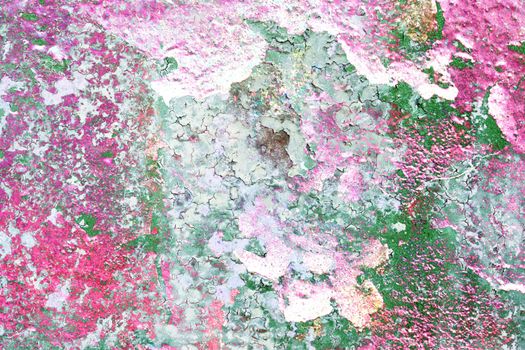 Detailed and colorful close up at cracked and peeling paint on concrete wall textures in high resolution.