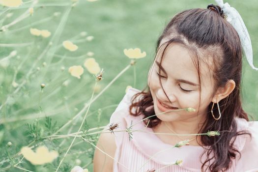 Portrait of asian happy woman smilling with flower garden , Selective focus