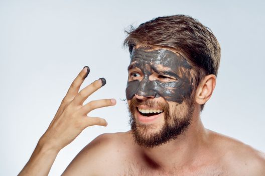 Man in black mask on face clean skin lifestyle naked shoulders hygiene health. High quality photo