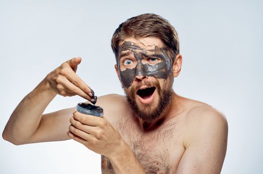 Man in black mask on face clean skin lifestyle naked shoulders hygiene health. High quality photo