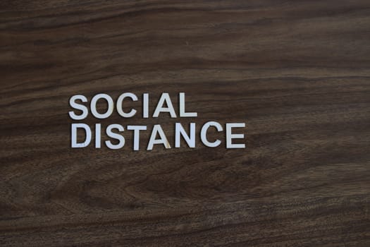 the term social distance on a wood background. High quality photo