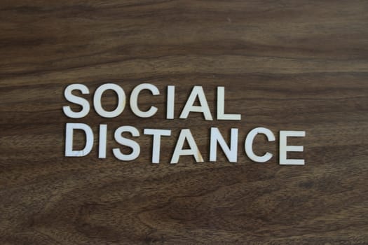 the term social distance on a wood background. High quality photo