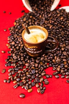 Cup of coffee, roasted coffee beans on red background, top view, copy space for text, coffee concept, close up coffee photo