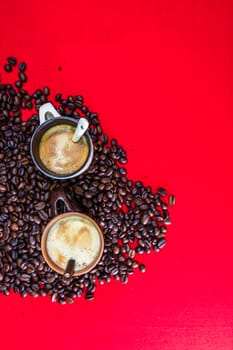 Cup of coffee, roasted coffee beans on red background, top view, copy space for text, coffee concept, close up coffee photo