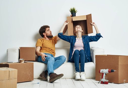 young couple in the room housewarming boxes with things moving emotions fun. High quality photo