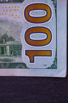 Selective focus on detail of 100 dollars banknote. Close up macro detail of money banknotes, dollars isolated. World money concept, inflation and economy concept