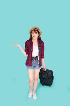 Beautiful young asian woman smiling and travel summer trip with luggage and presenting show something for abroad in vacation, asia girl having camera walking and pull suitcase for journey in holiday.