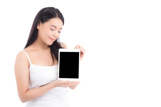 Portrait of asian young woman standing showing blank screen tablet isolated on white background, girl showing technology, business and communication concept.