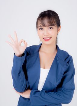 beautiful portrait young business asian woman standing gesture ok sign with confident isolated on white background, asia businesswoman career secretary work success with smiling and happy.