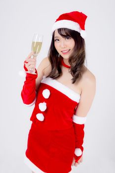 Beautiful portrait young asian woman in Santa holding glass of champagne with party celebrating in xmas holiday isolated on white background, asia girl drink beverage, Christmas and new year concept.