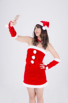 Beautiful portrait young asian woman in Santa cheerful taking a photo in Christmas holiday isolated on white background, asia girl selfie with phone celebrating in xmas with smiling and happy.