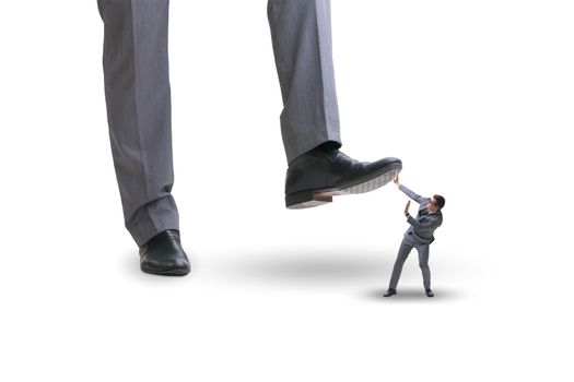Bad angry boss stamping on employee in business concept