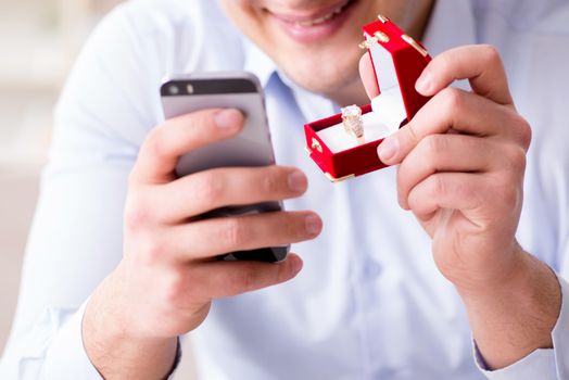 Young man chatting with his sweetheart over mobile phone