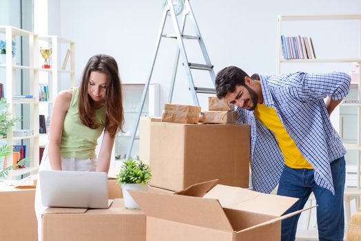 Young family unpacking at new house with boxes
