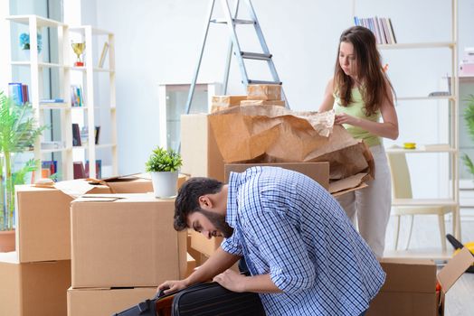 Young family unpacking at new house with boxes