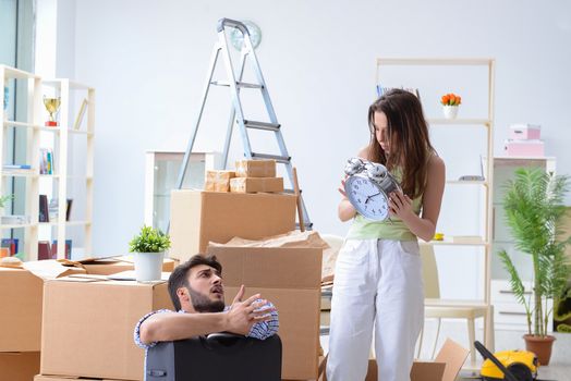 Young family unpacking at new house with boxes