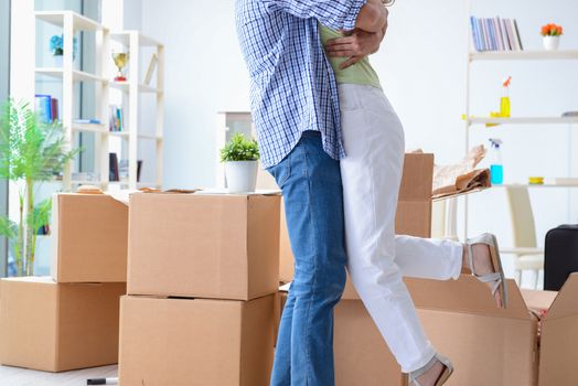 Young family unpacking at new house with boxes