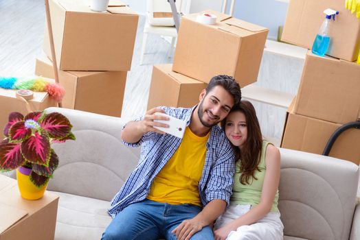 Young family unpacking at new house with boxes