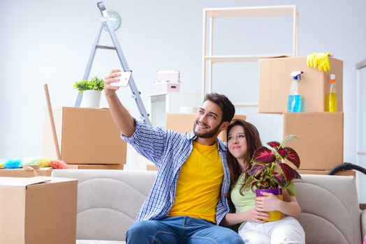 Young family unpacking at new house with boxes
