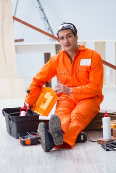 Contractor working on laminate wooden floor 