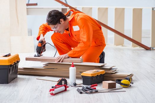 Contractor working on laminate wooden floor