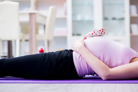 Pregnant woman exercising in anticipation of child birth