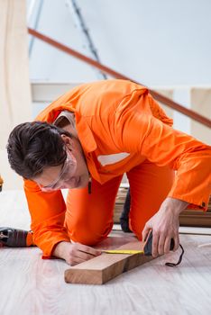 Contractor working on laminate wooden floor 