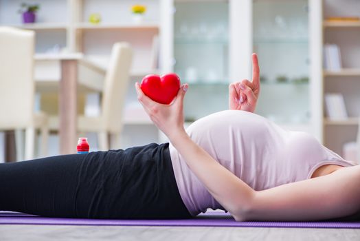 Pregnant woman exercising in anticipation of child birth