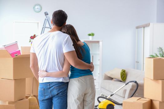 Young family unpacking at new house with boxes