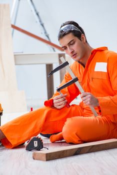 Contractor working on laminate wooden floor 
